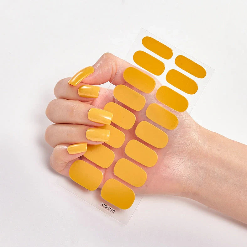 Nail art stickers with alphabet letters in sealed packaging, showing 16 designs per pack
