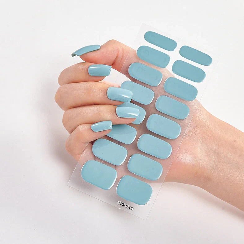 Nail art stickers with alphabet letters in sealed packaging, showing 16 designs per pack