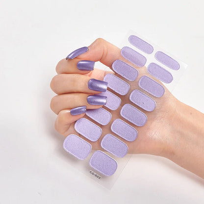 Nail art stickers with alphabet letters in sealed packaging, showing 16 designs per pack