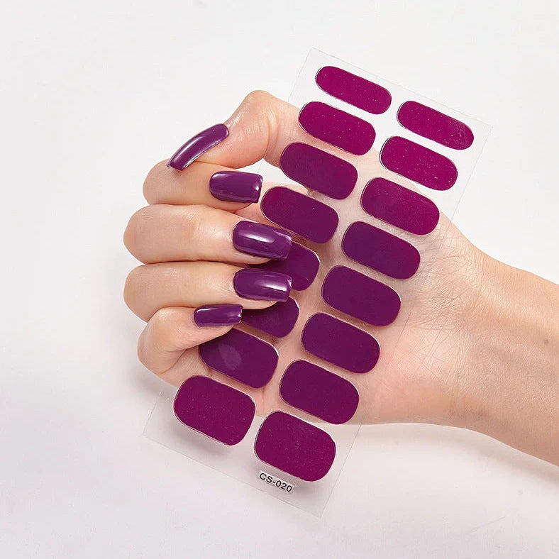 Nail art stickers with alphabet letters in sealed packaging, showing 16 designs per pack