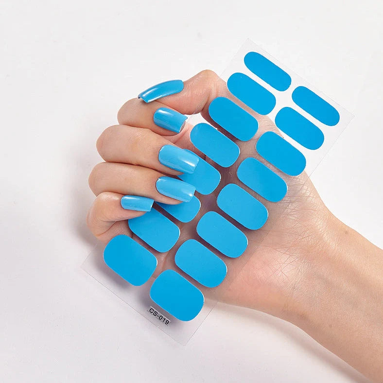 Nail art stickers with alphabet letters in sealed packaging, showing 16 designs per pack