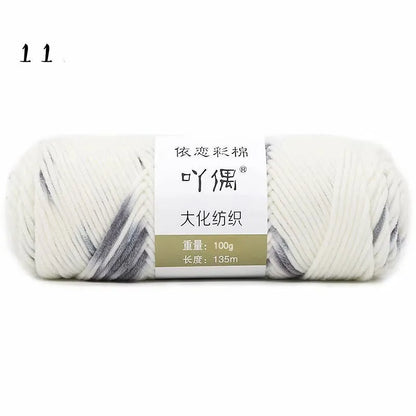 Eight strands of gradient milk cotton wool in a ball, showing multiple colour options for hand knitting.