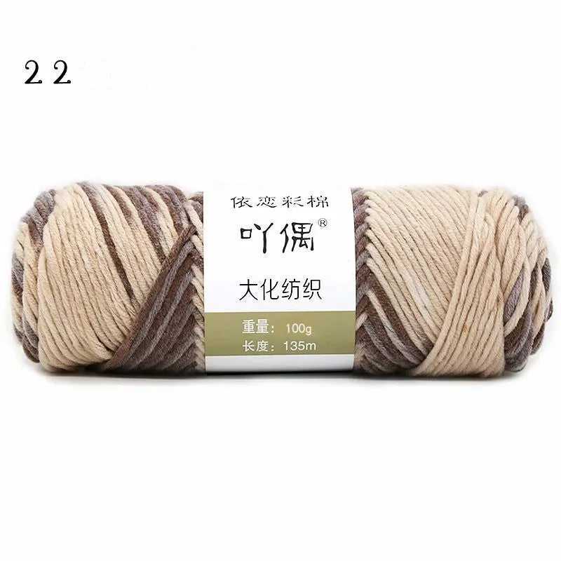 Eight strands of gradient milk cotton wool in a ball, showing multiple colour options for hand knitting.