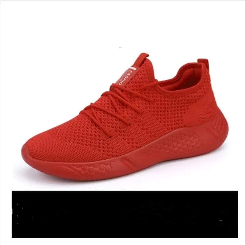 Men's black and white breathable mesh sneakers with round toe and lace-up closure on a grey background.