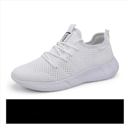 Men's black and white breathable mesh sneakers with round toe and lace-up closure on a grey background.