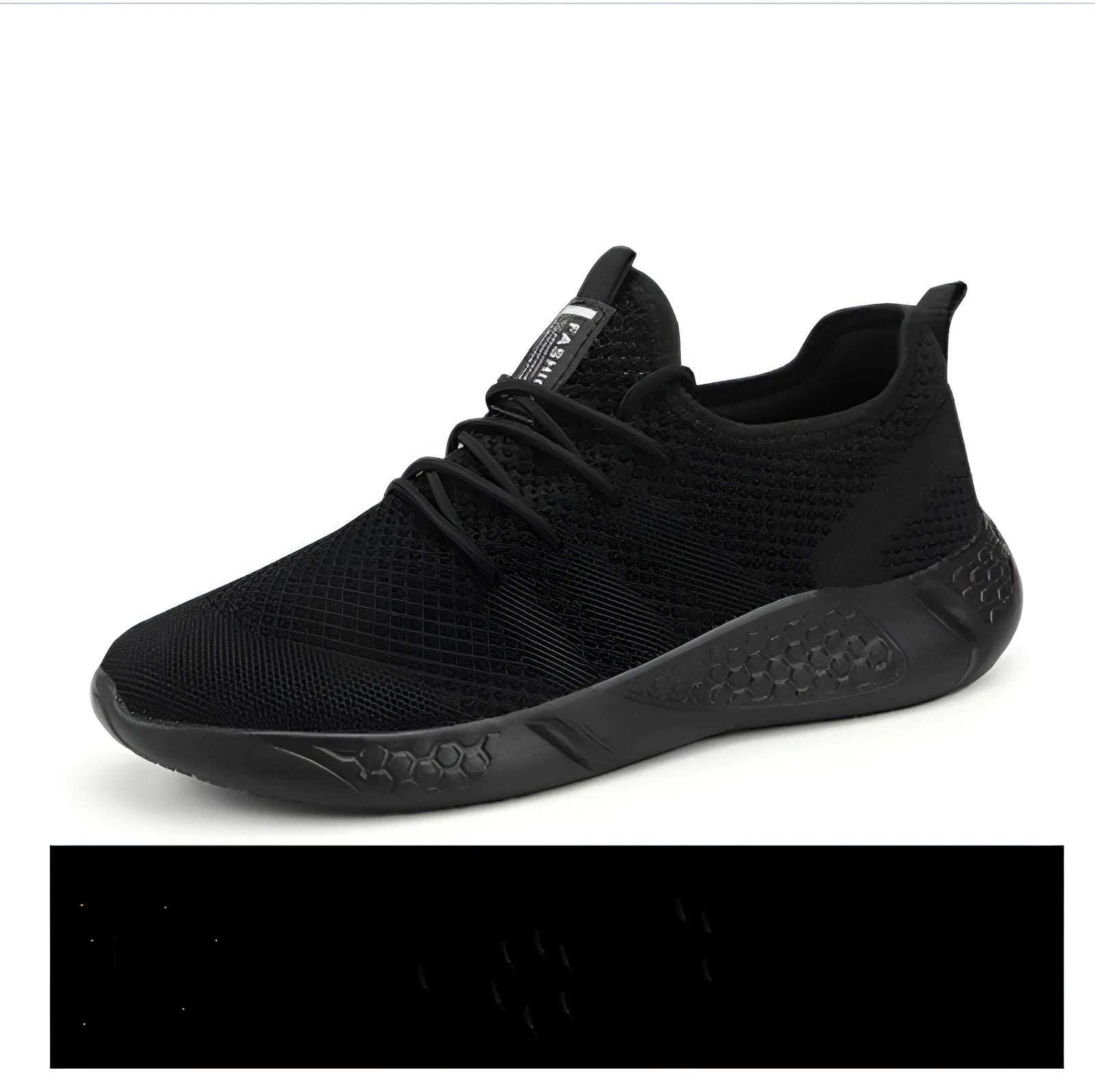 Men's black and white breathable mesh sneakers with round toe and lace-up closure on a grey background.