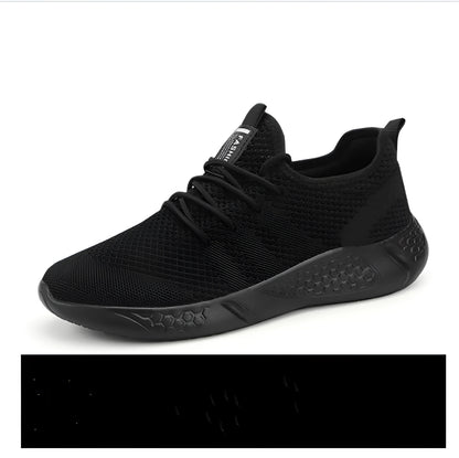 Men's black and white breathable mesh sneakers with round toe and lace-up closure on a grey background.