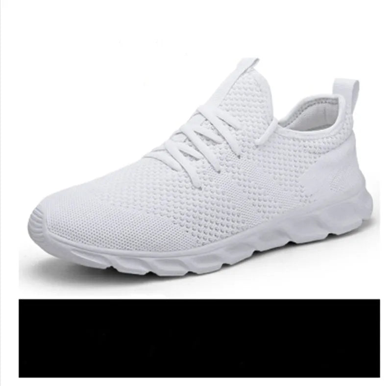 Men's black and white breathable mesh sneakers with round toe and lace-up closure on a grey background.