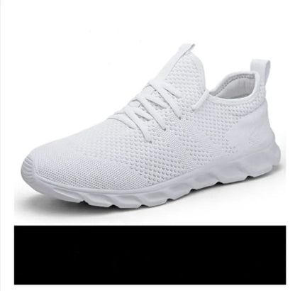 Men's black and white breathable mesh sneakers with round toe and lace-up closure on a grey background.