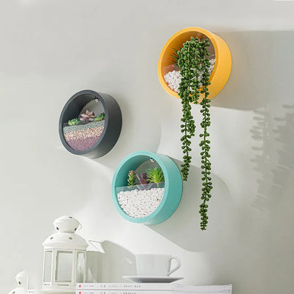 Round iron style plastic wall vase hanging basket for flowers in multiple colour options.