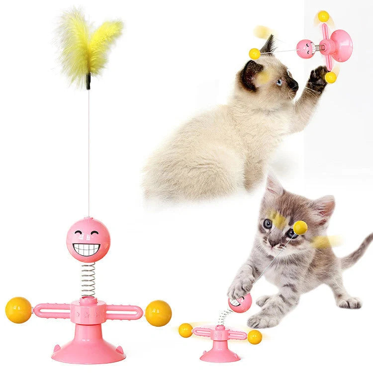 Cat playing with rotating windmill toy featuring luminous balls and suction base