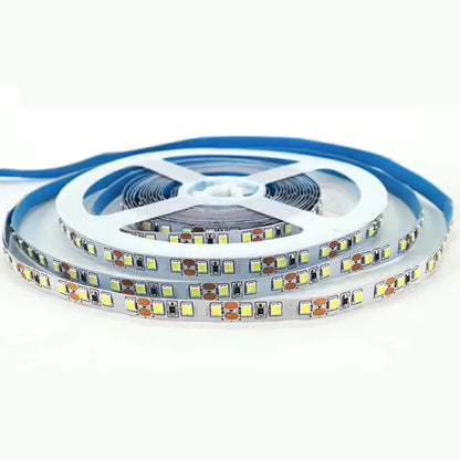 Close-up of flexible white LED light strip with 5050 SMD chips, showing cut points and adhesive backing.