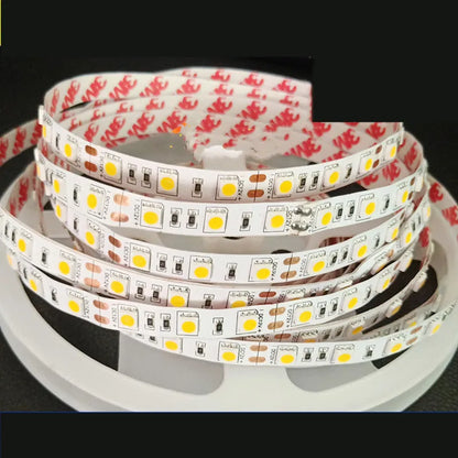 Close-up of flexible white LED light strip with 5050 SMD chips, showing cut points and adhesive backing.