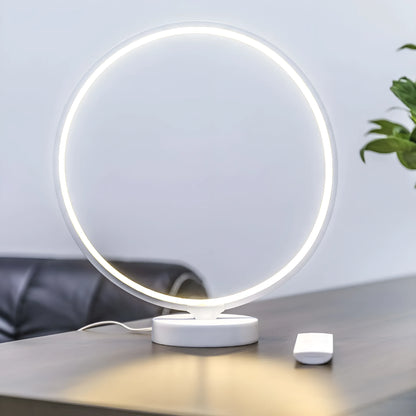 White full moon shaped table lamp with remote control on a table