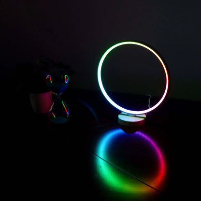 White full moon shaped table lamp with remote control on a table