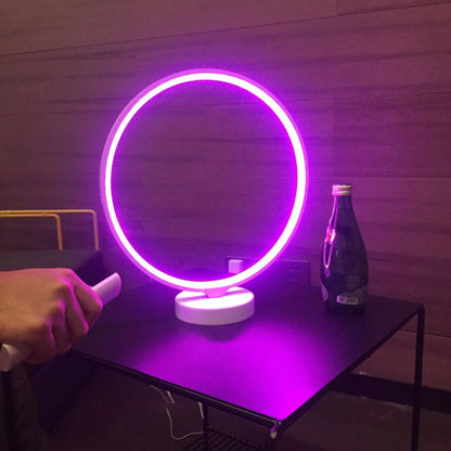 White full moon shaped table lamp with remote control on a table
