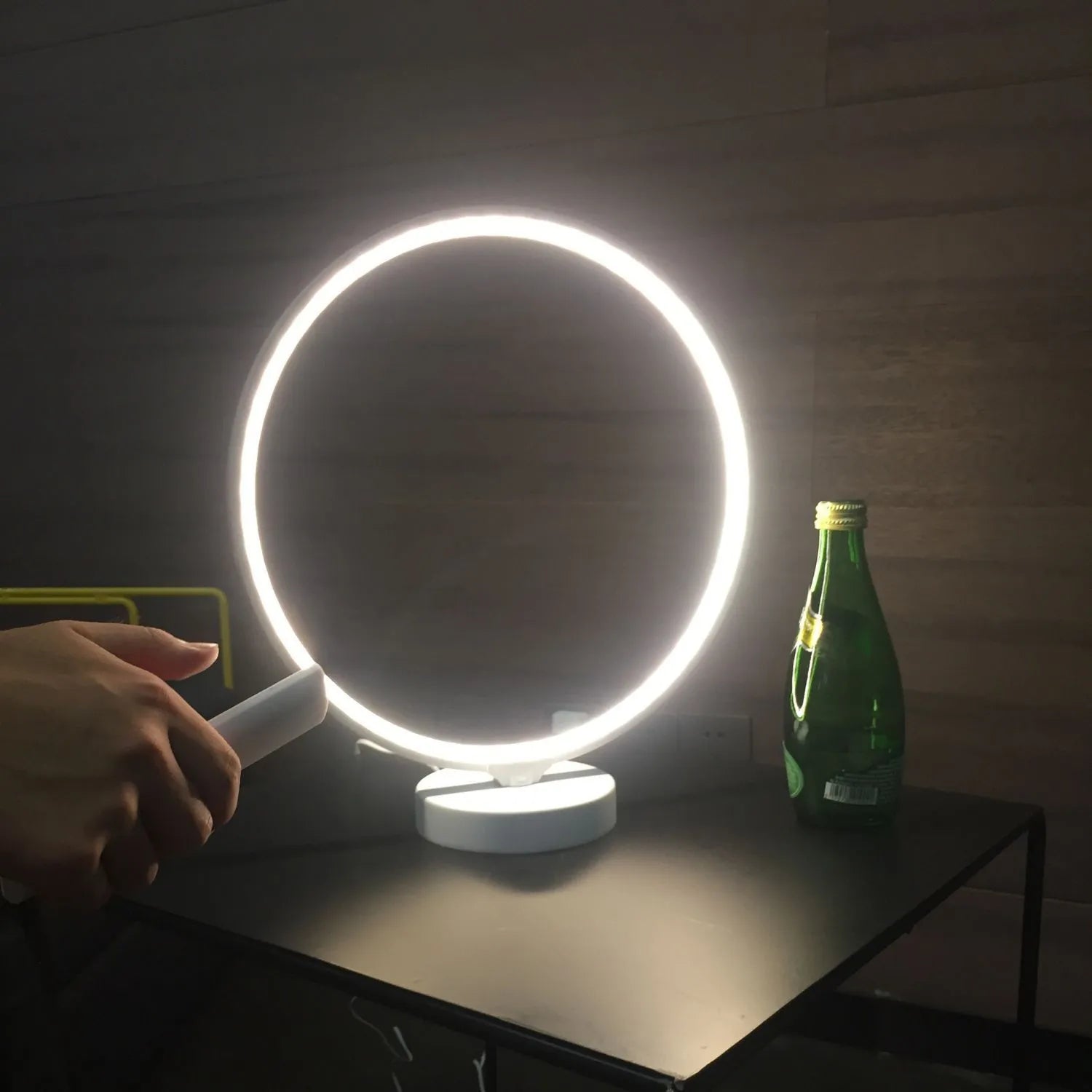 White full moon shaped table lamp with remote control on a table