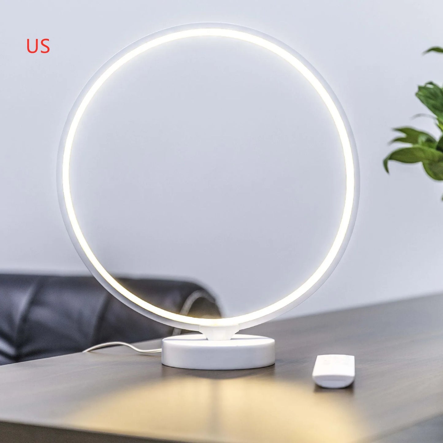 White full moon shaped table lamp with remote control on a table