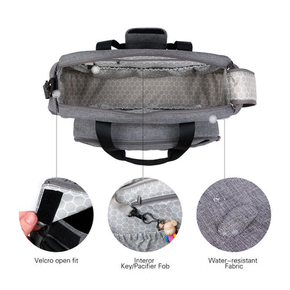 Convertible baby diaper bag in black and grey, transforms into crib and changing table