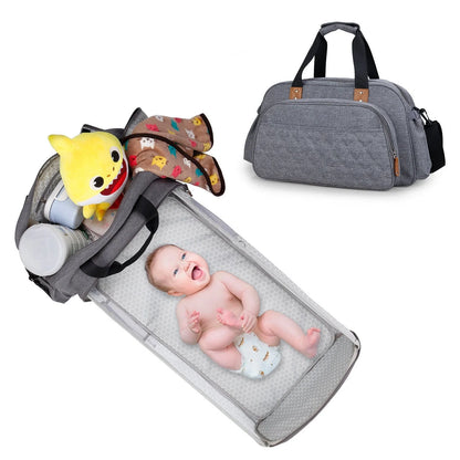 Convertible baby diaper bag in black and grey, transforms into crib and changing table