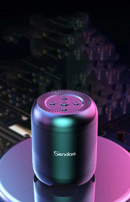 Small black or white wireless Bluetooth speaker with super subwoofer on a desk.