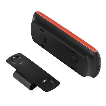 Orange plastic Bluetooth hands-free car speaker clipped to a car sun visor