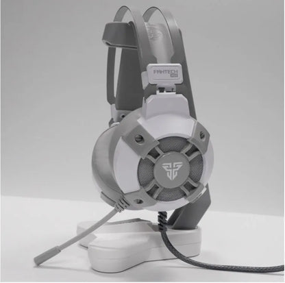 Black FANTECH HG11 USB gaming headset showing over-ear design, RGB lights on cups, and inline remote on cable.