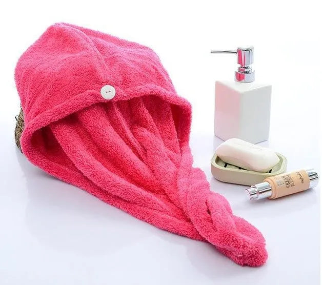 A woman wearing a sky blue microfiber hair dryer cap, with wet hair tucked inside, showing the towel's wrap-around design.