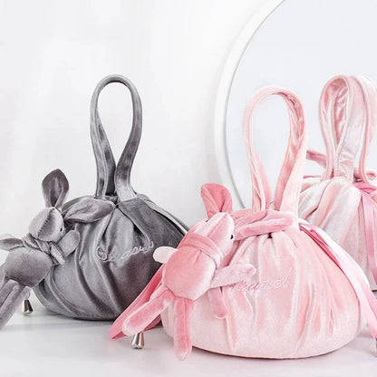 Adorable rabbit ear velvet cosmetic bags in various colors for storing and organizing makeup, toiletries, and other beauty essentials.