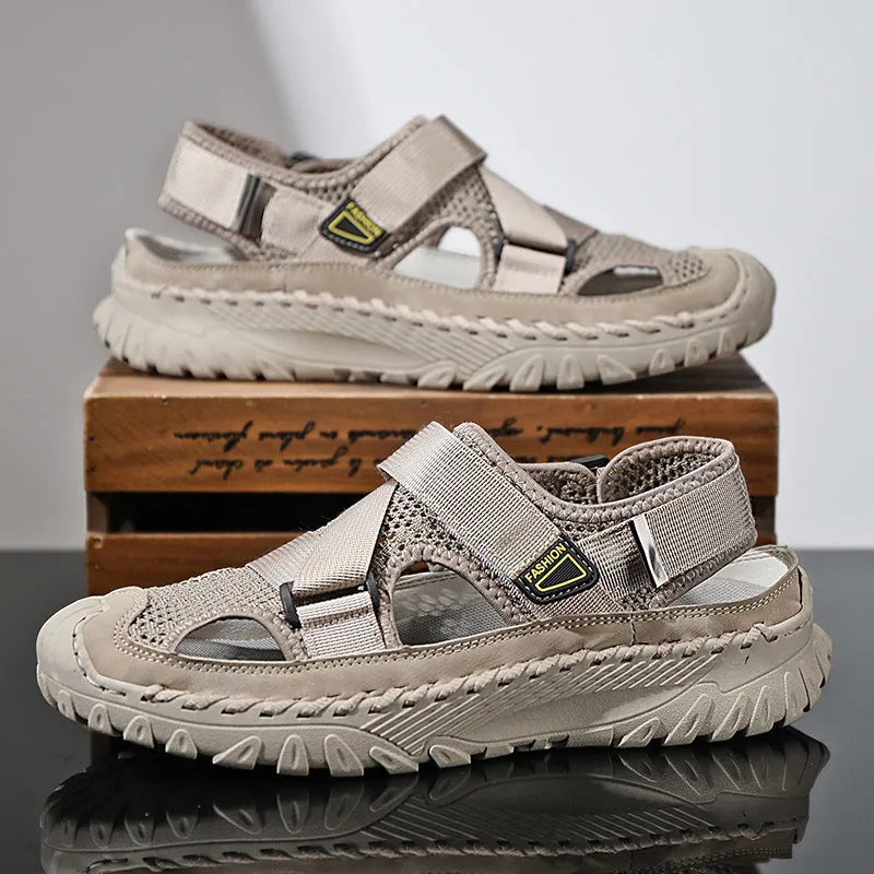 Men's gray casual sandals with mesh panels, leather upper, elastic strap, and rubber sole.