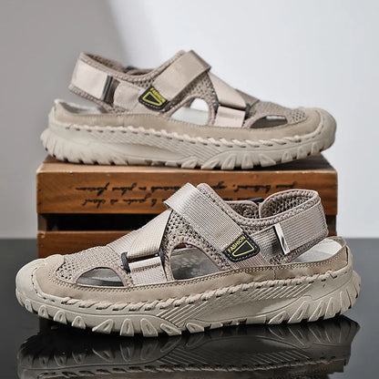 Men's gray casual sandals with mesh panels, leather upper, elastic strap, and rubber sole.