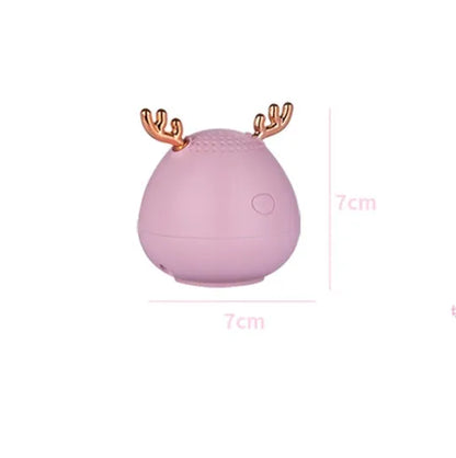 Compact portable Bluetooth speaker in white, pink or green with USB charging cable