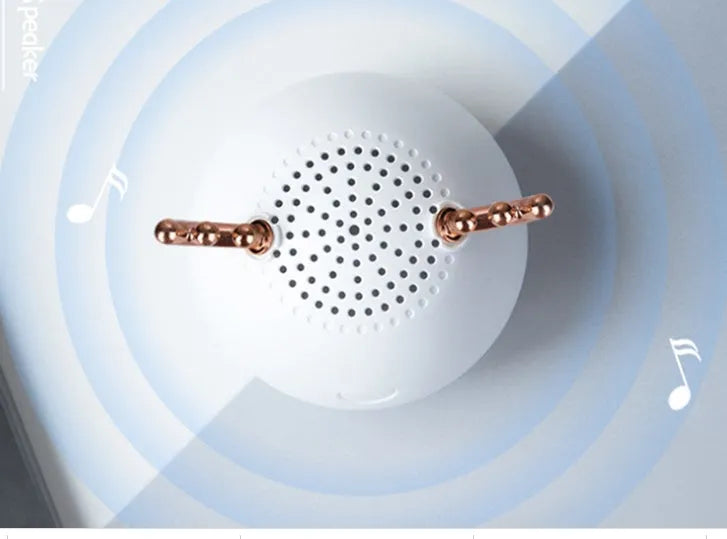 Compact portable Bluetooth speaker in white, pink or green with USB charging cable