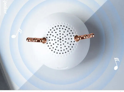 Compact portable Bluetooth speaker in white, pink or green with USB charging cable