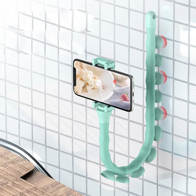 Black flexible rubber phone holder with suction cup bent into an S-shape, showing 360-degree rotation joint.