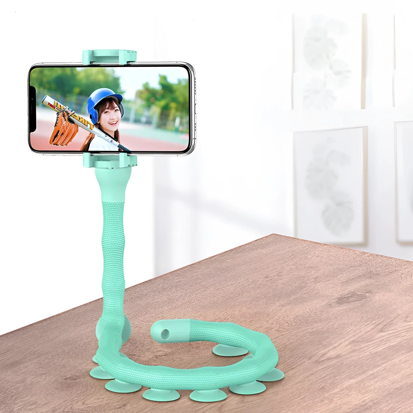 Black flexible rubber phone holder with suction cup bent into an S-shape, holding a mobile phone.