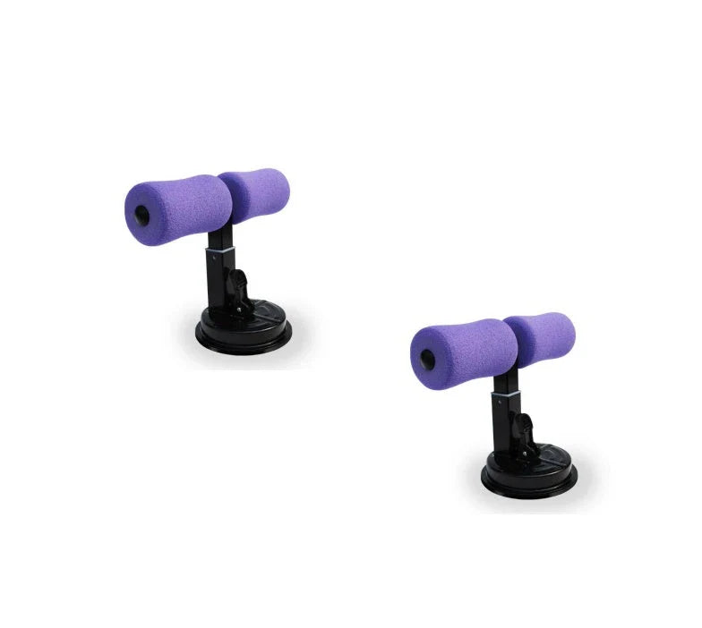 Compact sit-up strength trainer with steel springs and foam padding for home fitness