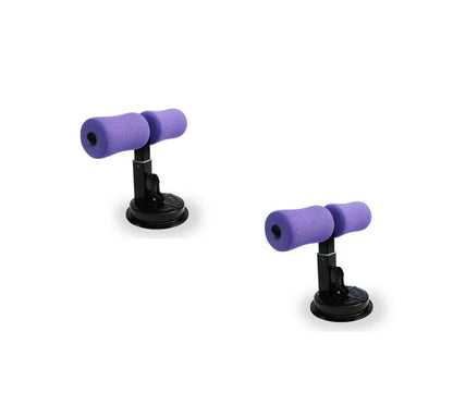 Compact sit-up strength trainer with steel springs and foam padding for home fitness