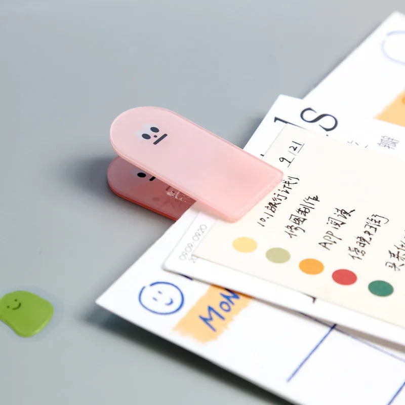 Colourful cartoon design printed on a transparent acrylic stationery clip.