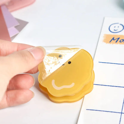 Colourful cartoon design printed on a transparent acrylic stationery clip.