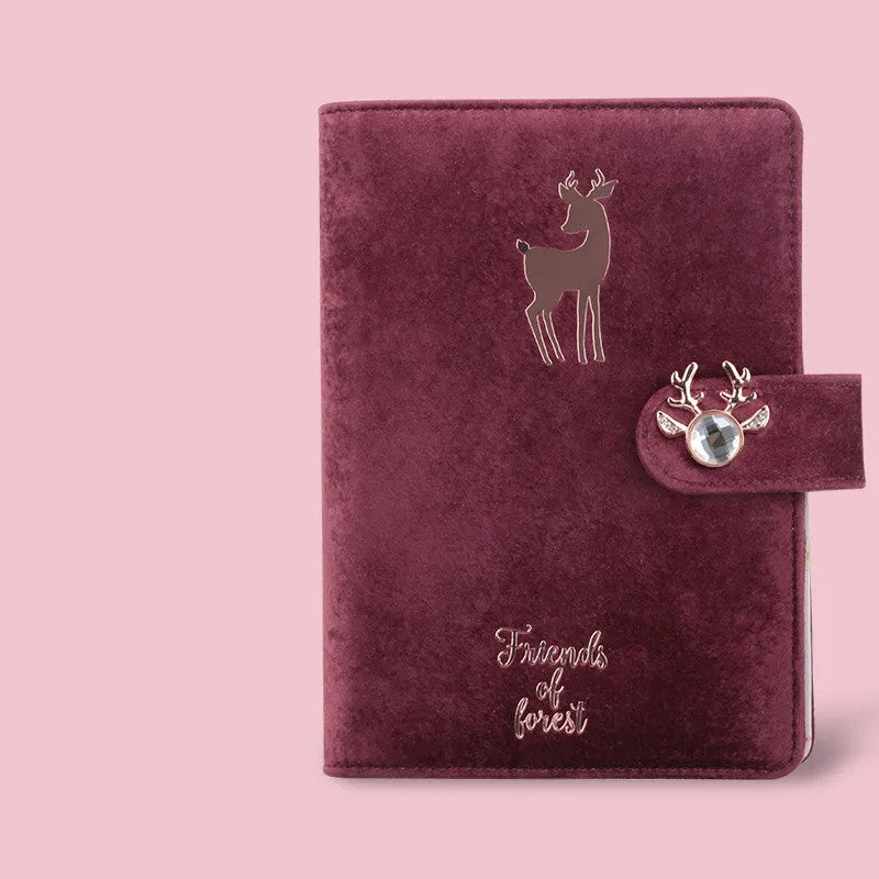 A6 loose-leaf notebook with blue velvet cloth cover open to show binder rings and paper.