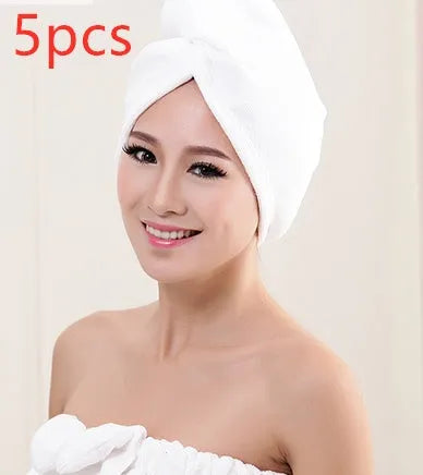 A woman wearing a sky blue microfiber hair dryer cap, with wet hair tucked inside, showing the towel's wrap-around design.