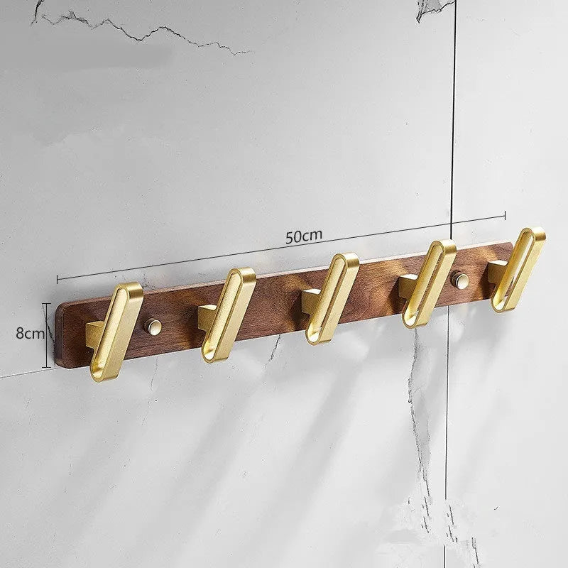 Black walnut wood clothes hooks with brass-finished aluminium frame in a 4-hook wall-mounted style