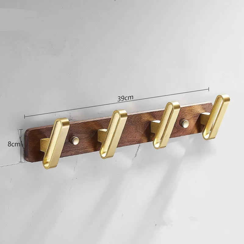 Black walnut wood clothes hooks with brass-finished aluminium frame in a 4-hook wall-mounted style