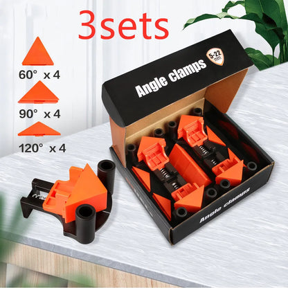 Four white plastic right angle clamps for woodworking and picture frame assembly on a workbench.