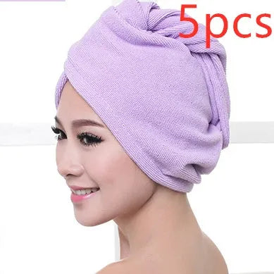 A woman wearing a sky blue microfiber hair dryer cap, with wet hair tucked inside, showing the towel's wrap-around design.