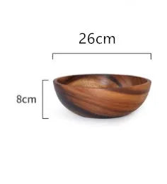 Set of five brown wooden bowls in different sizes on a wooden table, showing natural grain.