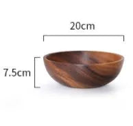 Set of five brown wooden bowls in different sizes on a wooden table, showing natural grain.