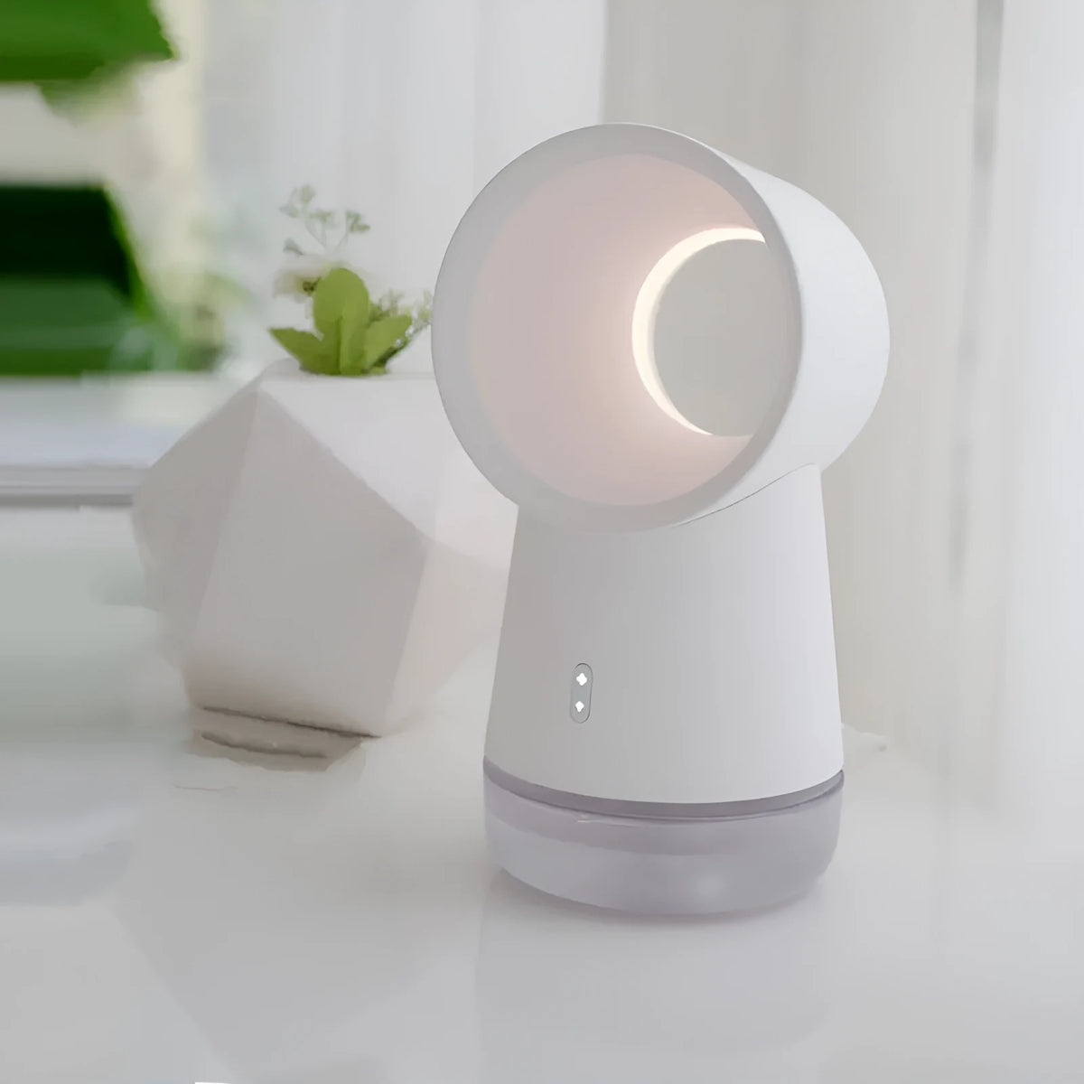 White round desktop humidifier with leafless fan, USB cable, and single mist outlet on a desk