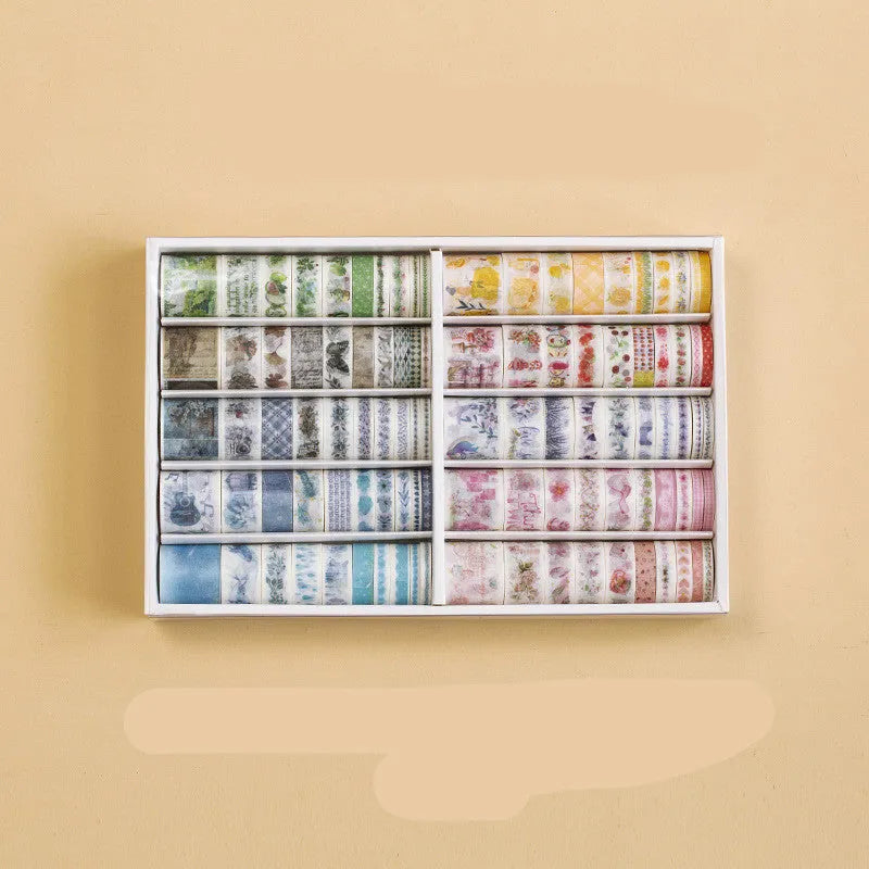 Box of 100 antique character decorative paper tape rolls in assorted colours and widths for accounting and crafts.